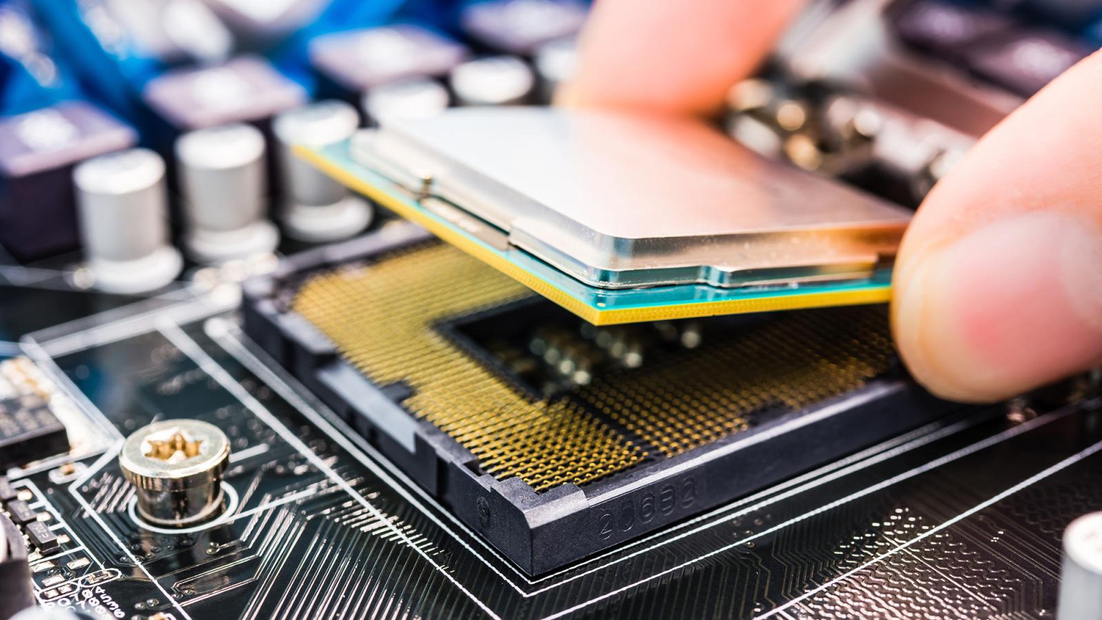 Image of a chip being inserted into a computer.