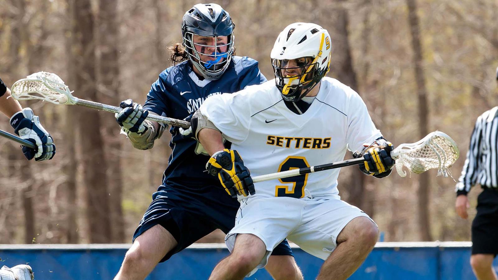 A Pace lacrosse athlete defends against a rival player 