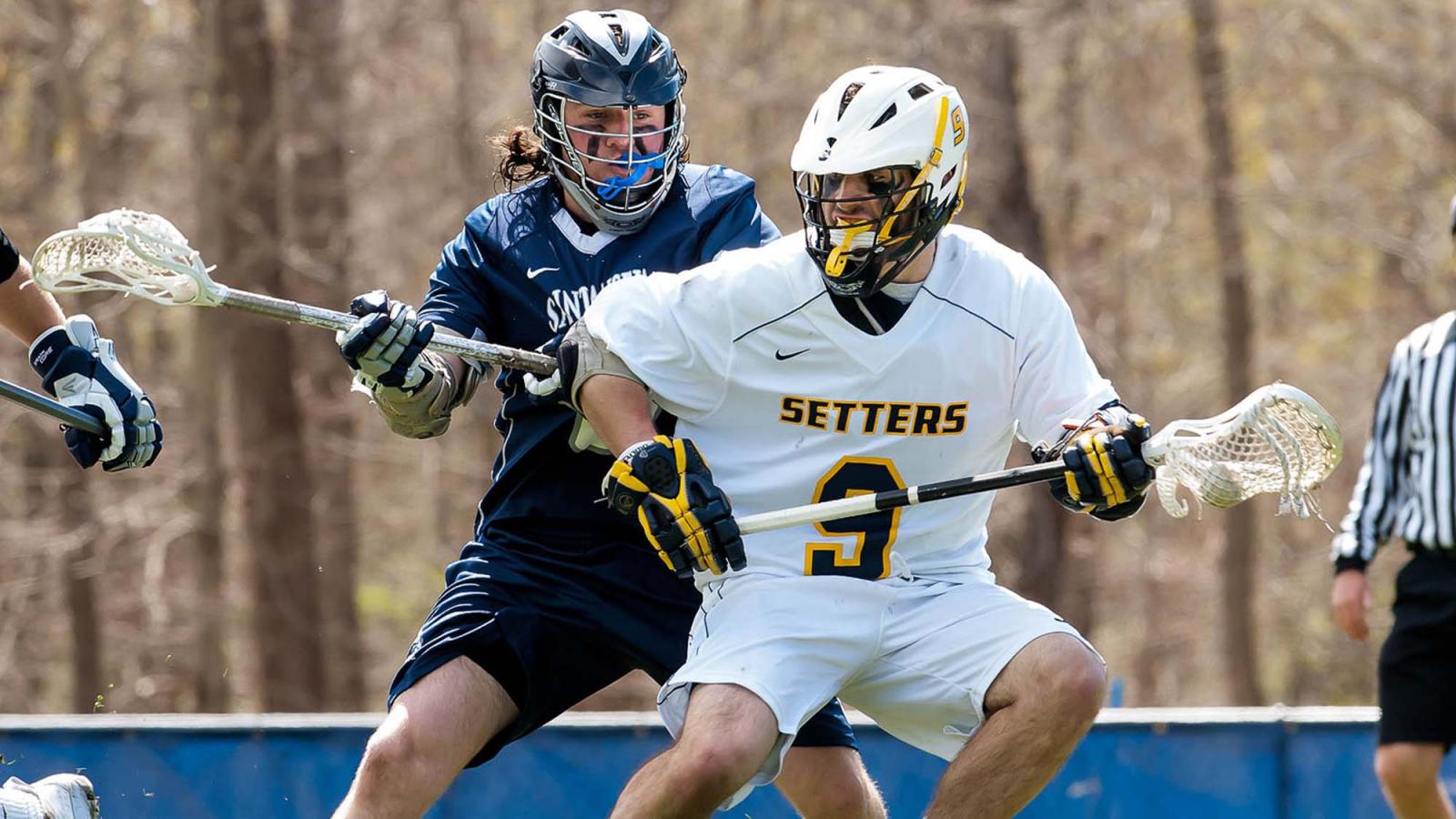 A Pace lacrosse athlete defends against a rival player