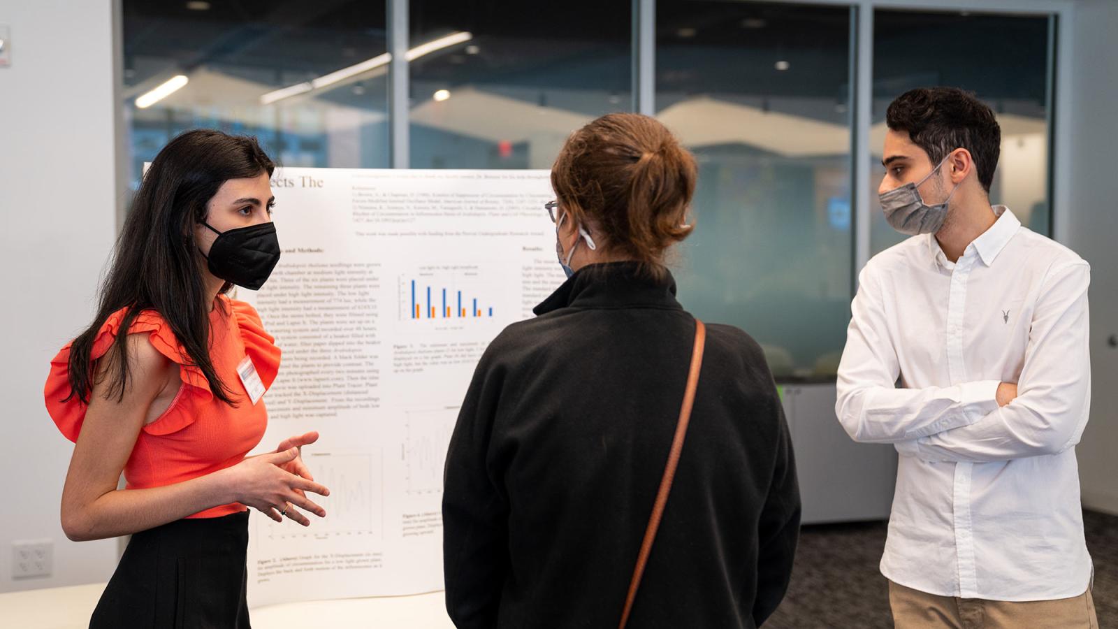 students and teacher discussing research