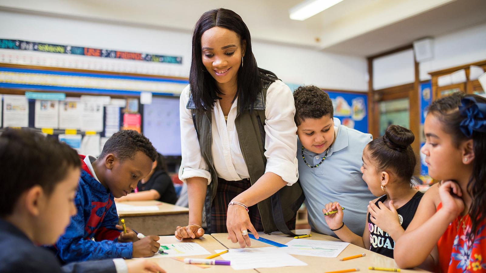 School of Education student working in a classroom setting with young children.