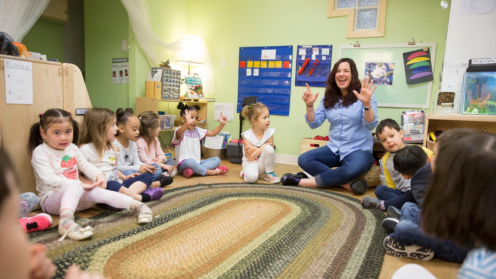 School of Education alumn working in a classroom with children.