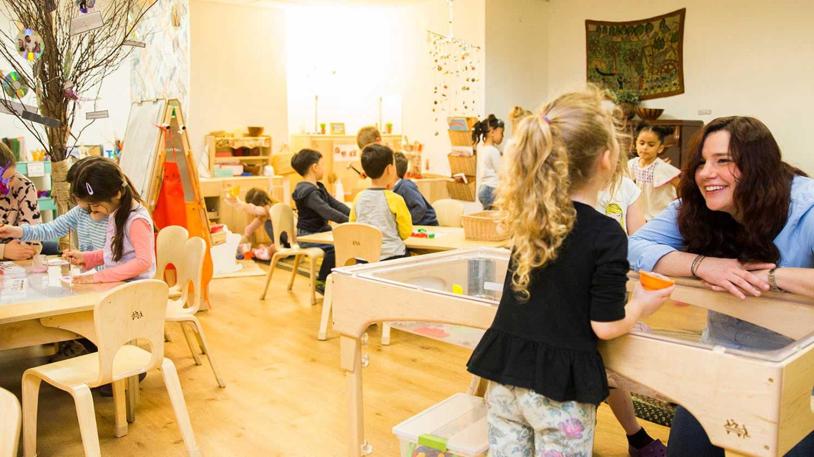 Student working with children in a classroom setting.