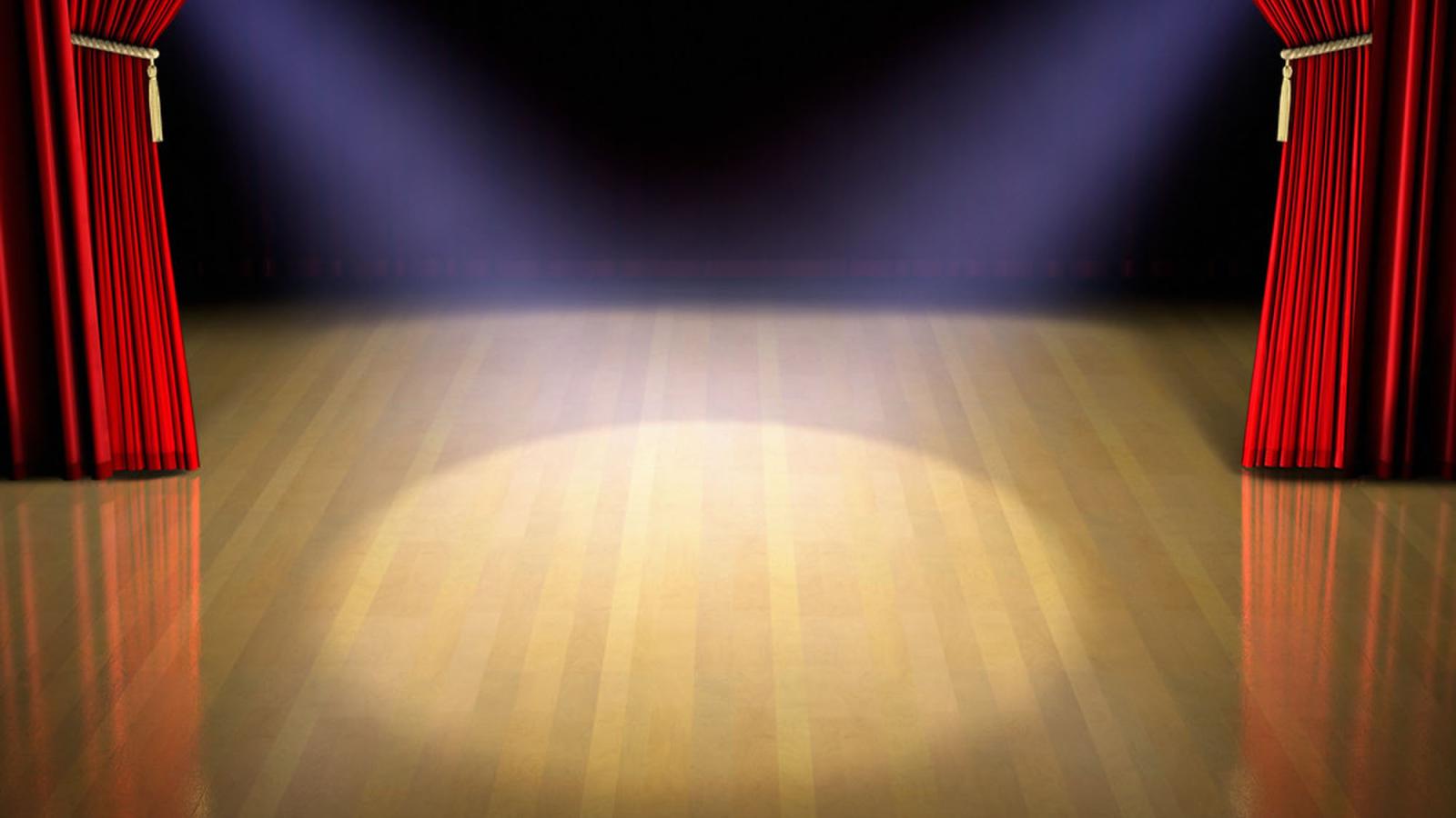 graphic of spotlight on theater stage with red curtains