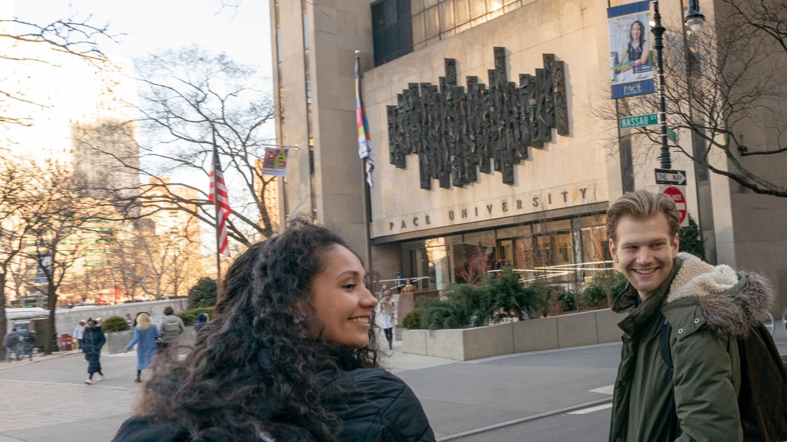 two students walking near One Pace Plaza