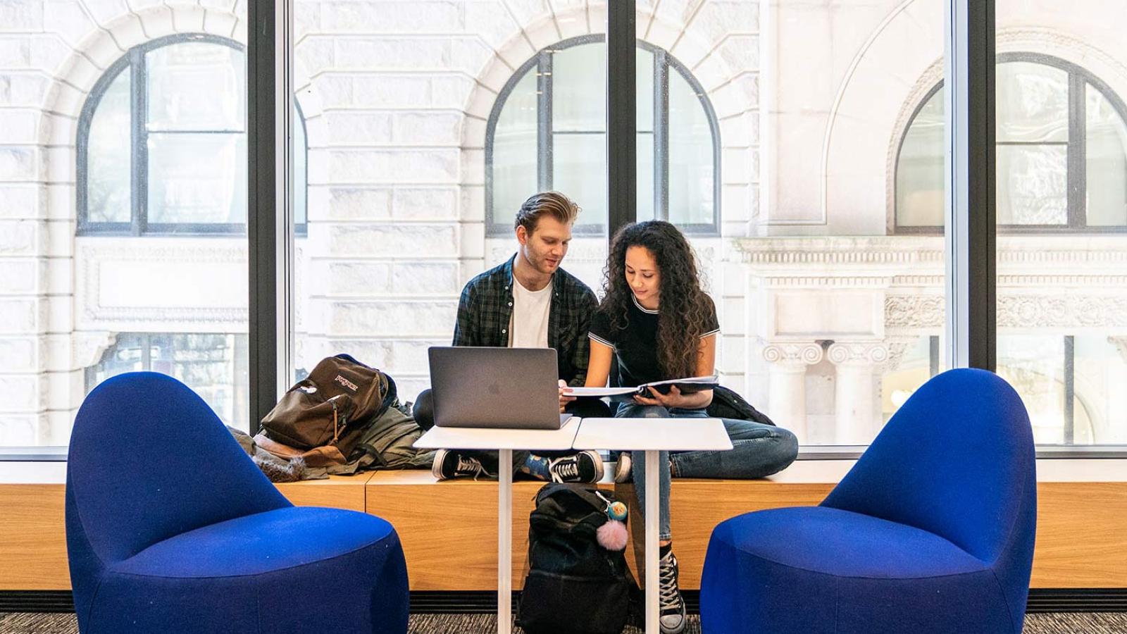 Students sitting at a table studying.