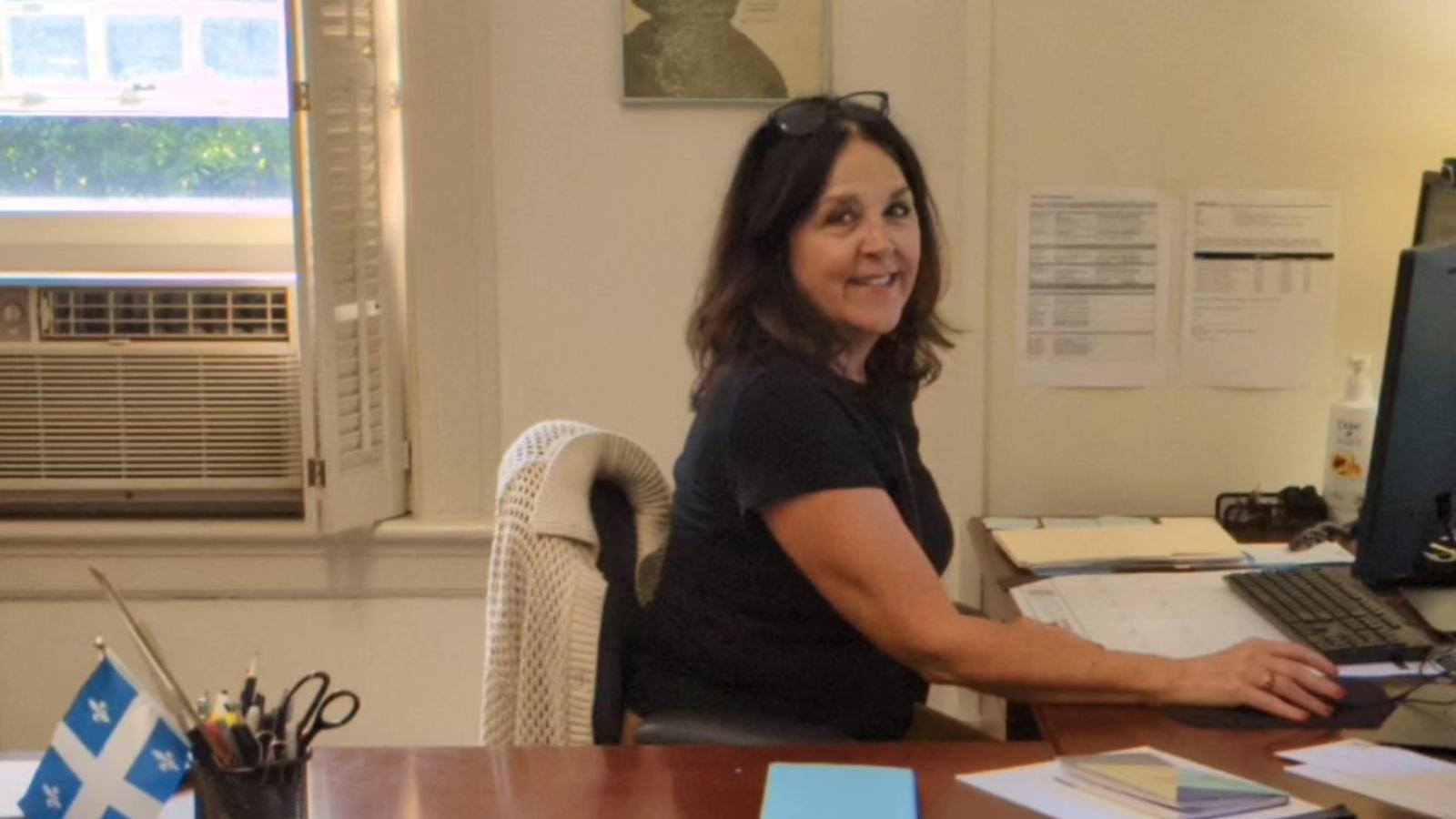 woman smiling at her desk