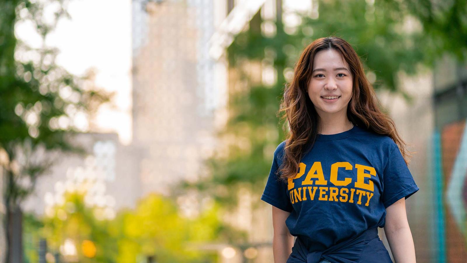 Hinako Tanakamaru faces the camera wearing a blue and gold Pace t-shirt