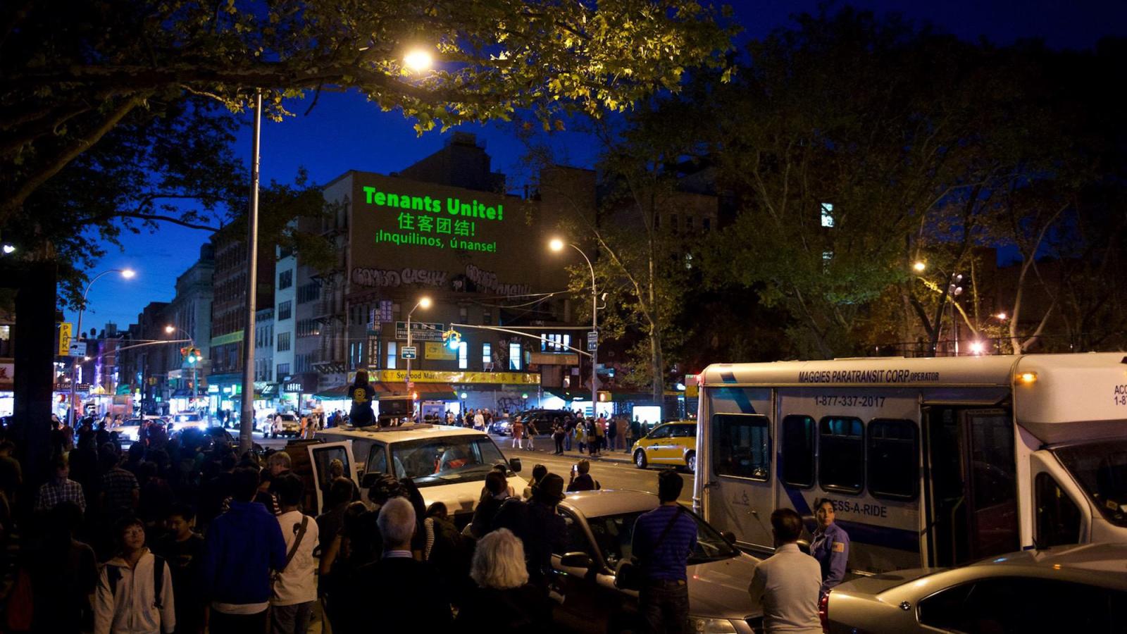 NYC street with people gathered to watch an event