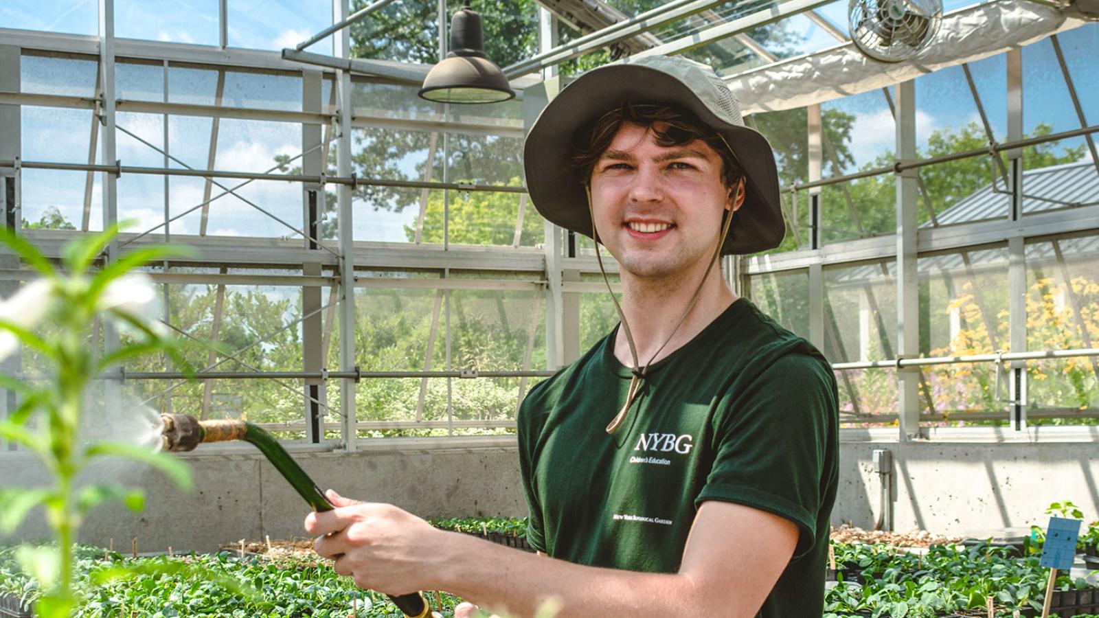 Student working at his internship taking care of plants.