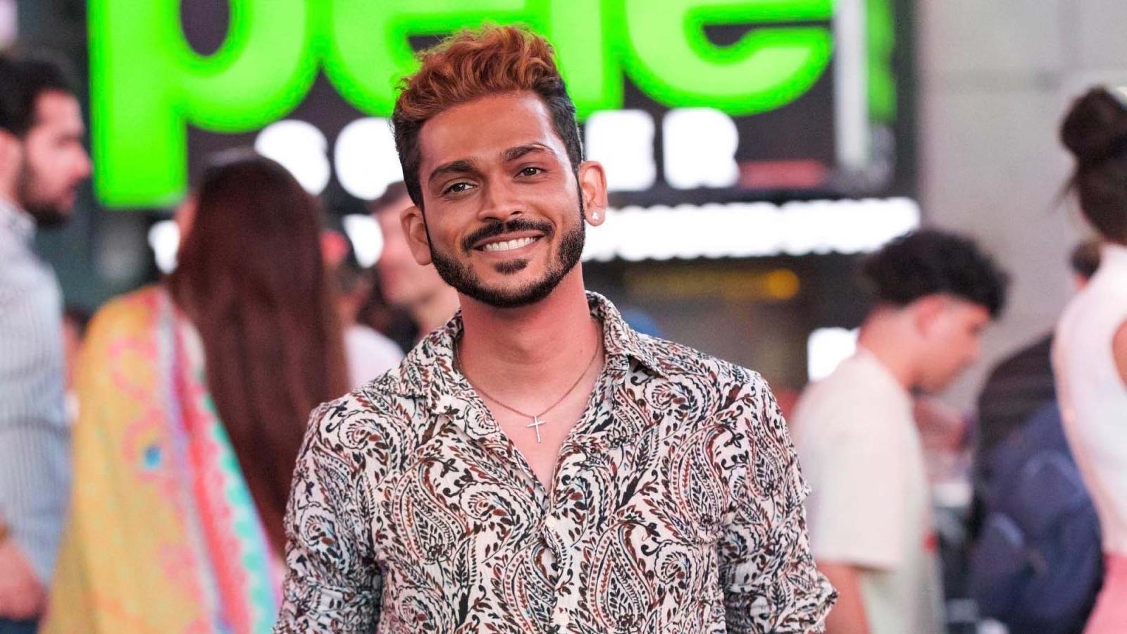 Chinmay Bonde, wearing a colorful shirt, stands in a crowd