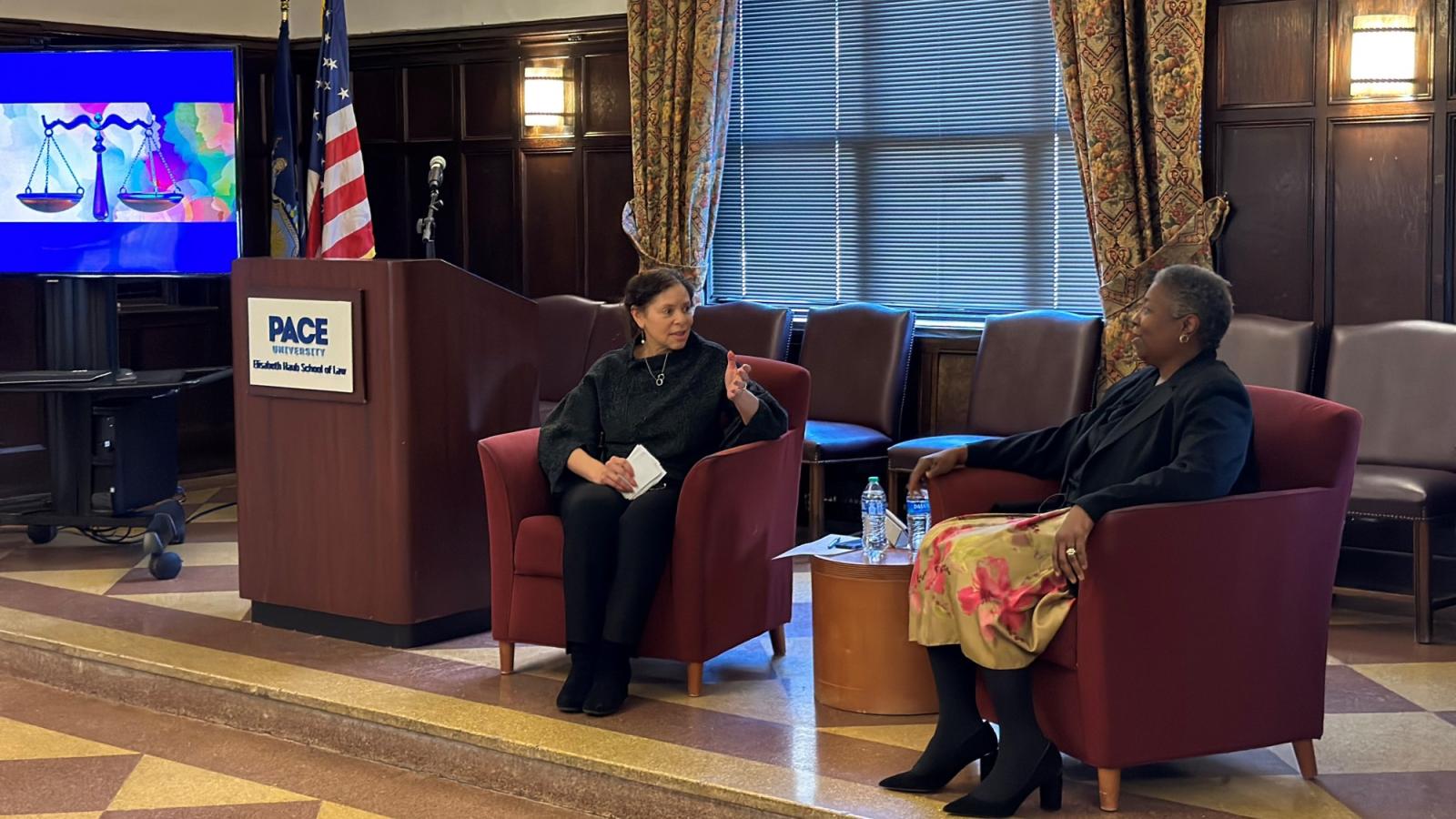 Professor Barbara Atwell on stage in Tudor room with Marcia Sells