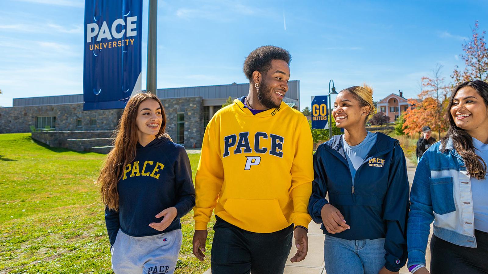 Group of students walking around the Pleasantville campus.