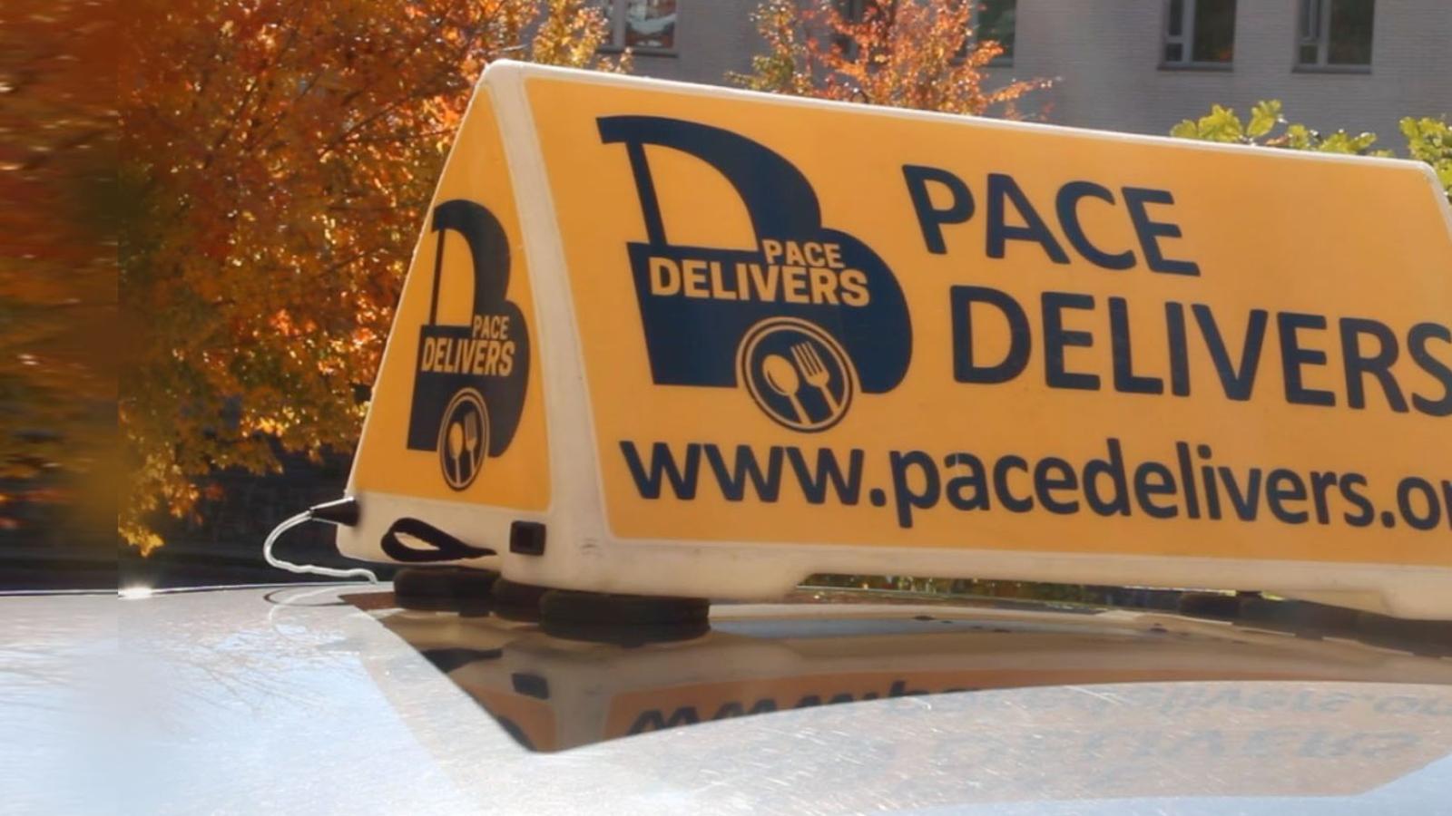 roof of car with sign of Pace Delivers, the student-run food delivery service on the Pleasantville Campus