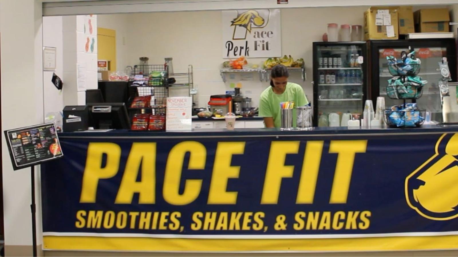 The Pace Fit student-run smoothie and healthy snack bar on the Pleasantville Campus with student working behind counter