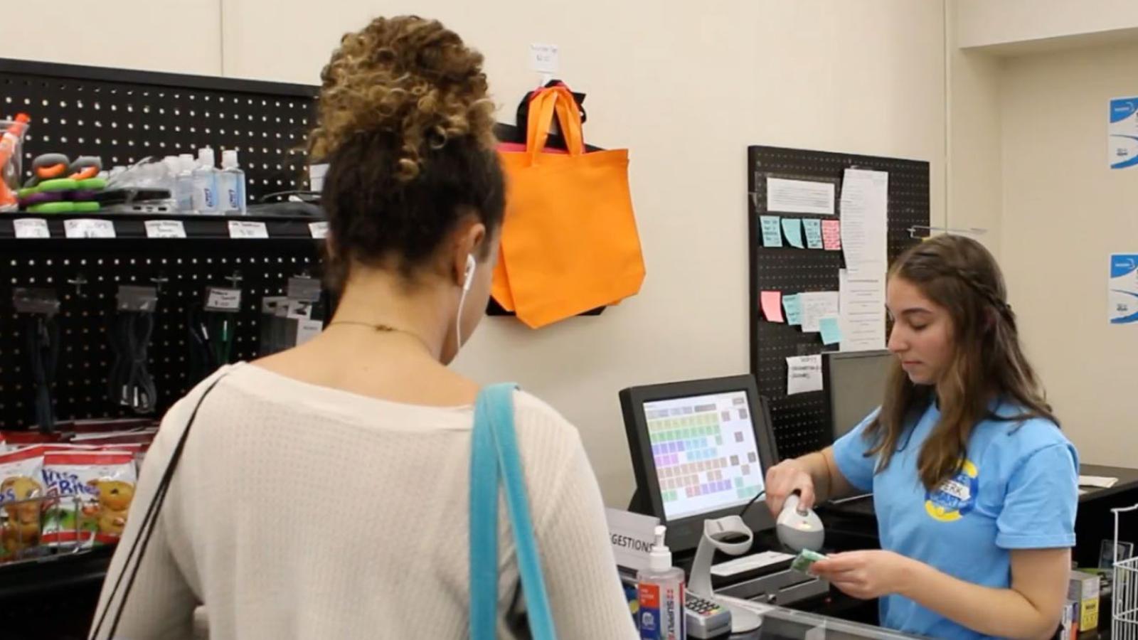 cashier and customer at Pace Mart, the student-run store on the Pleasantville Campus