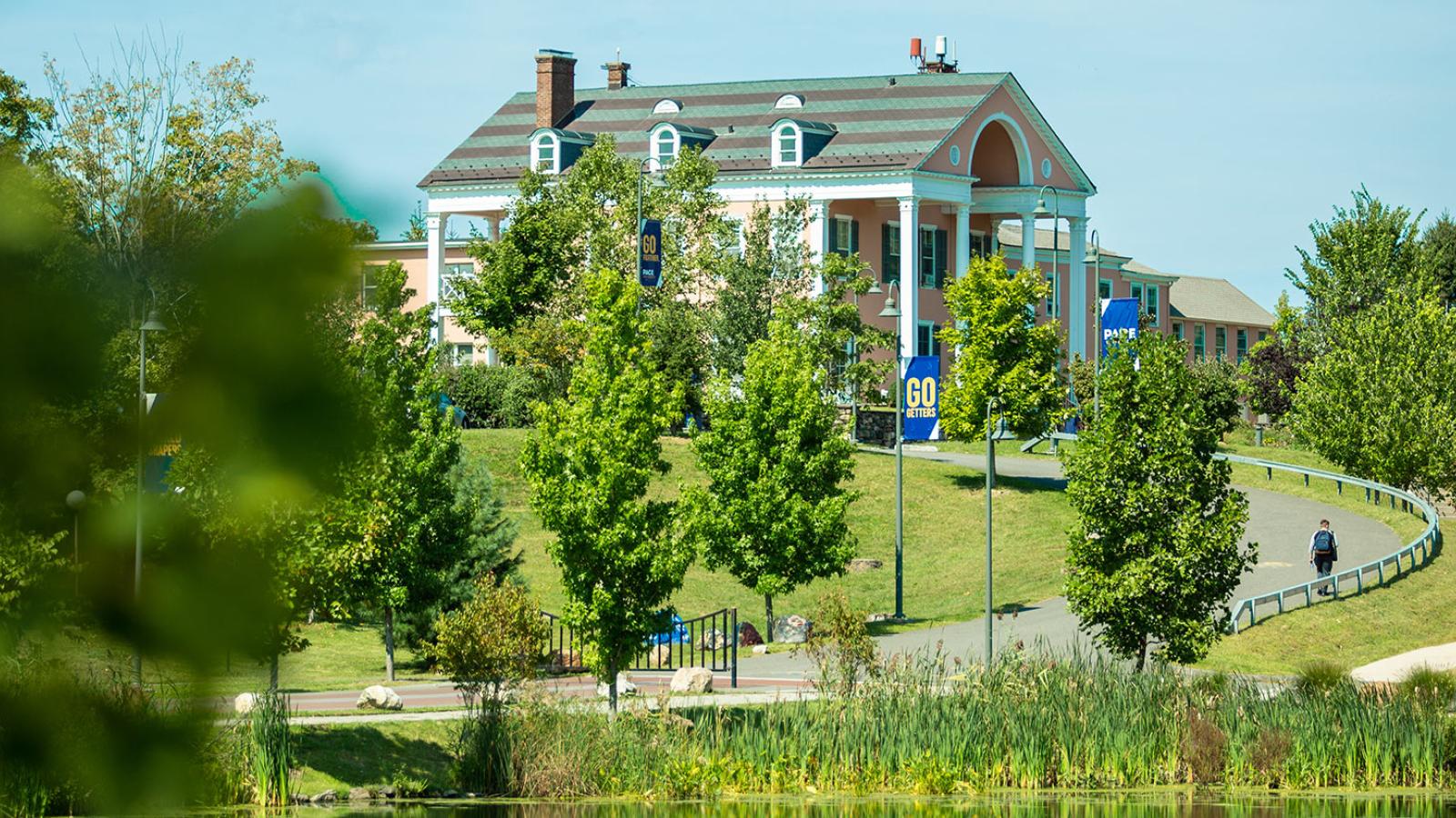 Landscape with lots of trees and a building sitting up on a hill in the background