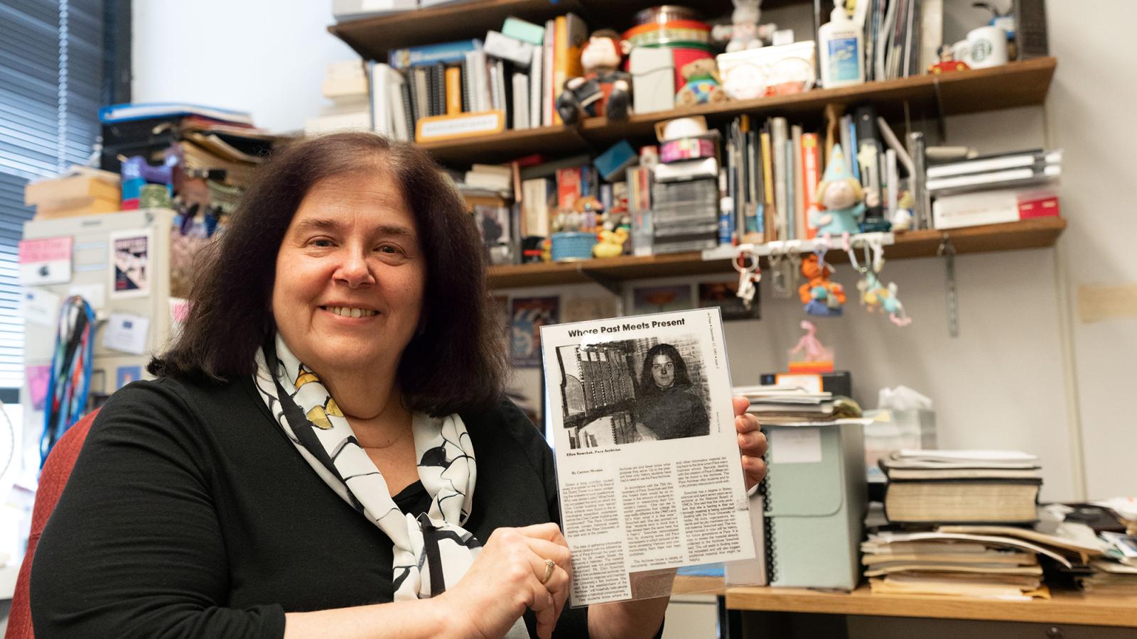 Ellen Sowchek holds up a newspaper clipping of her first day at Pace