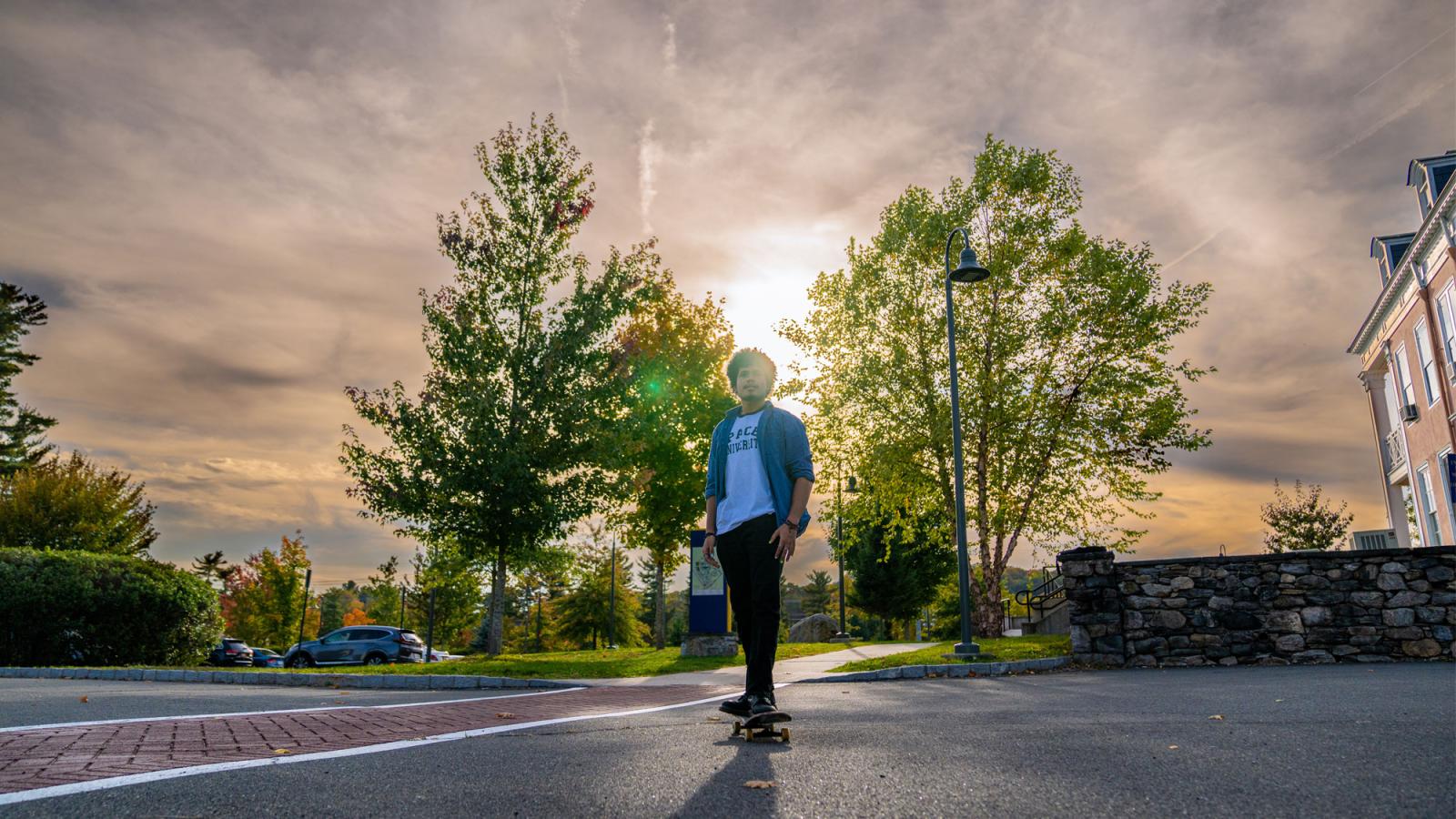 pace student skateboarding at sunset on the westchester campus. 