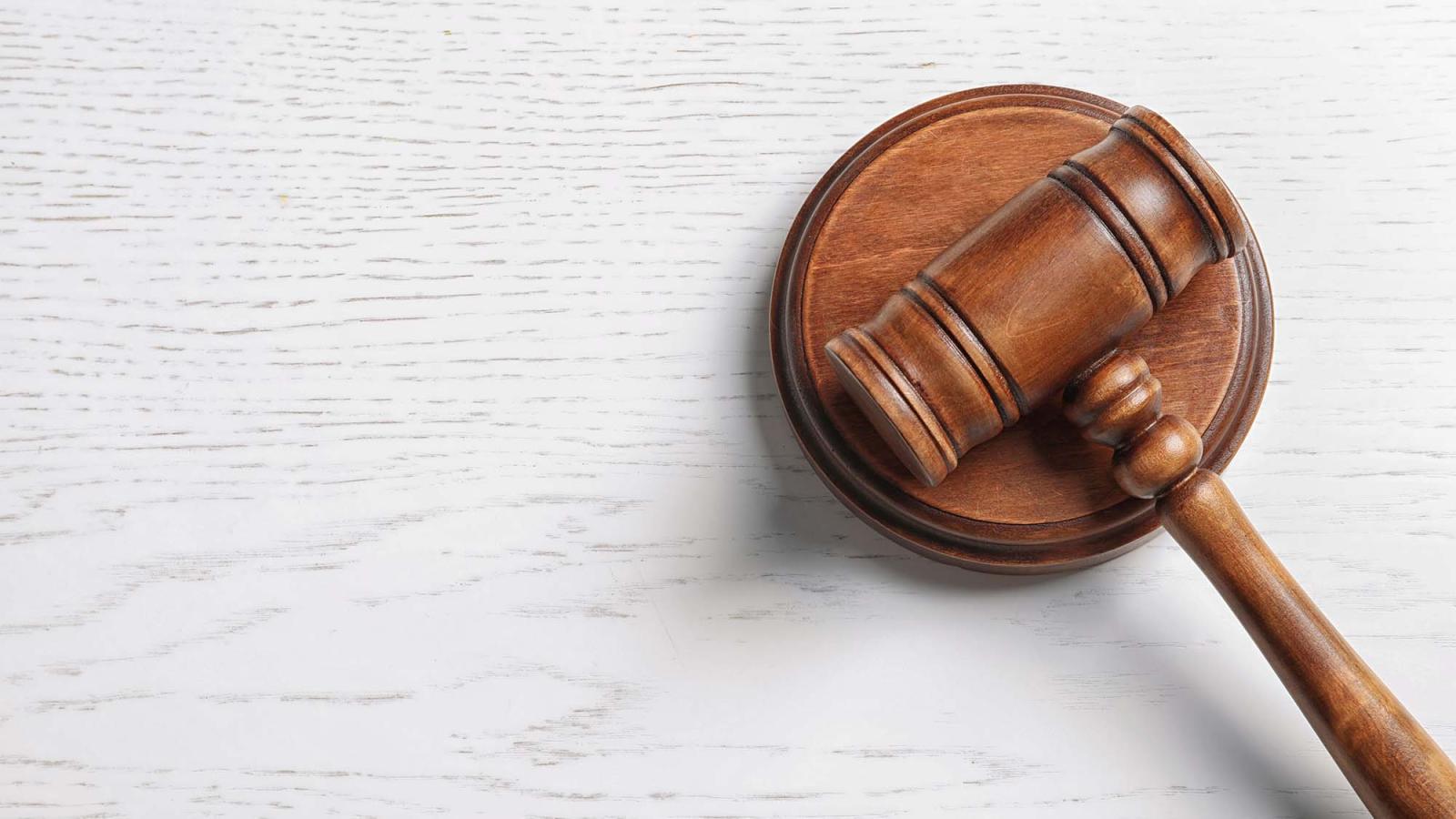 a wooden gavel on a marble background