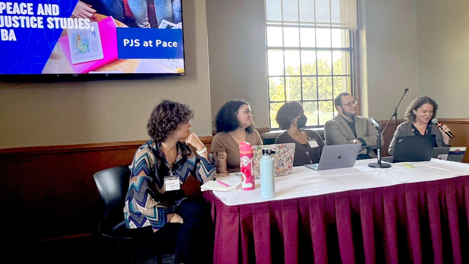 Pace University's Peace and Justice Studies student Camden Robertson at the table with others for the Peace and Justice Association Annual Conference