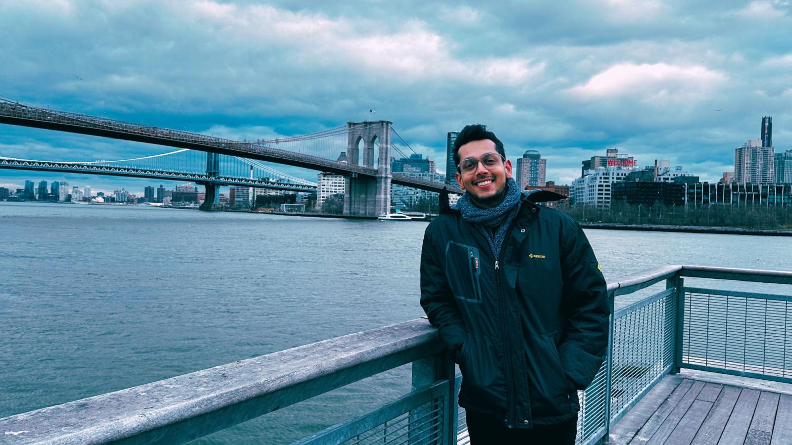 Seidenberg student Nishant Doshi stands before the Brooklyn Bridge