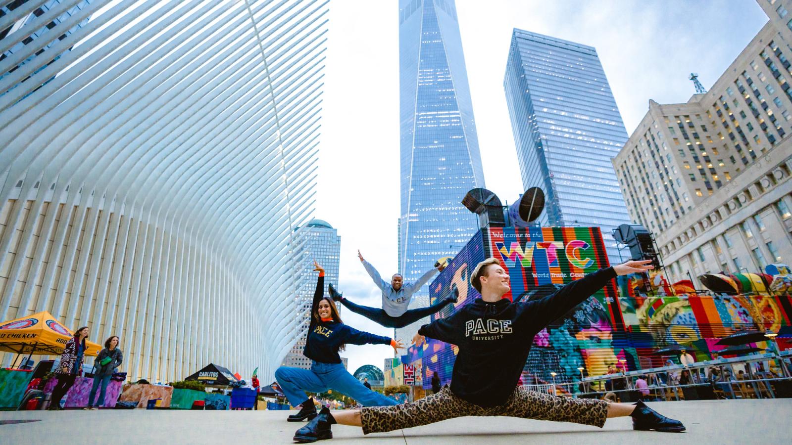 Performing arts students striking poses near the Oculus.