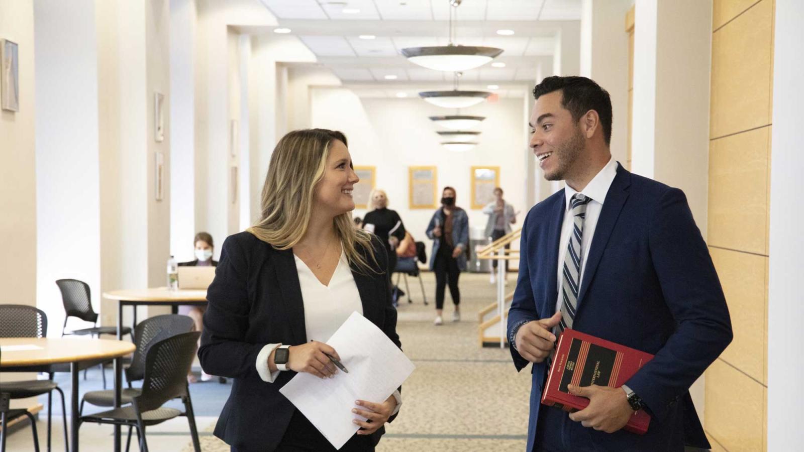 two students convering at Haub Law Campus