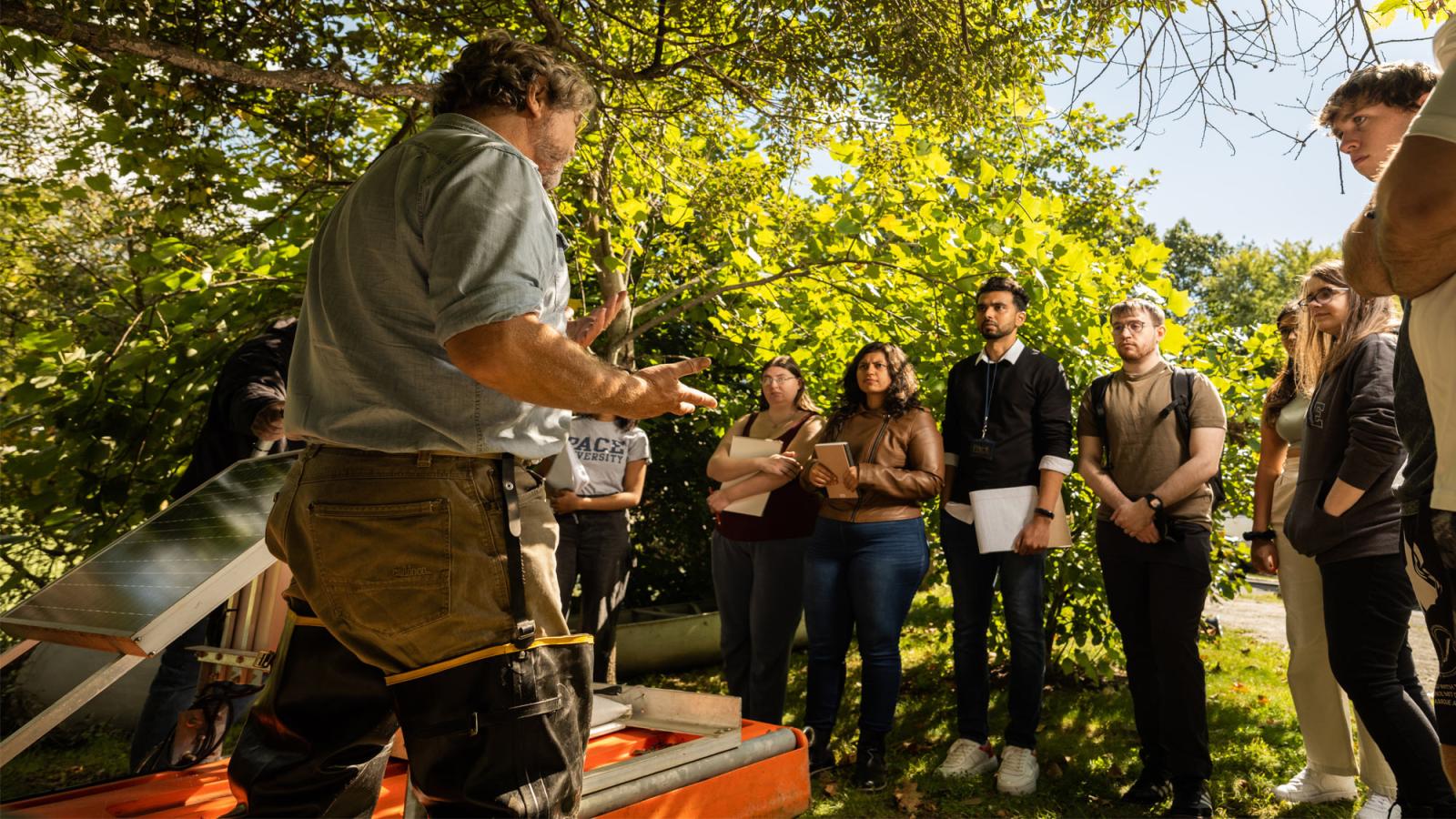 John Cronin and the Blue CoLab students outside near Choat Pond