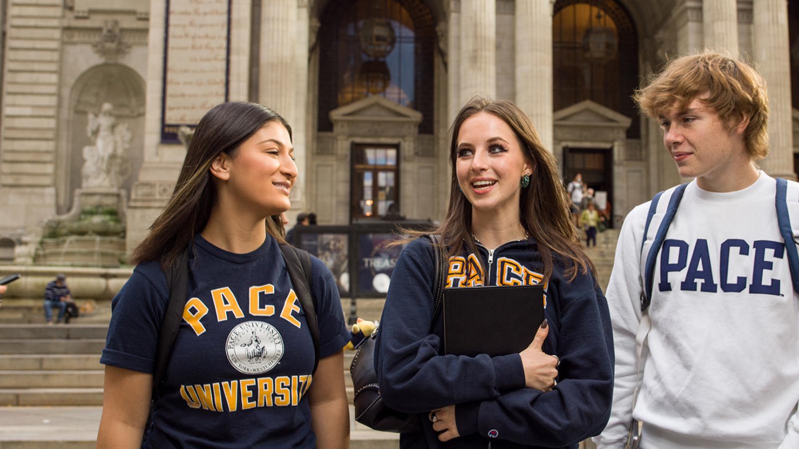 3 Pace University students walking in downtown Manhattan.