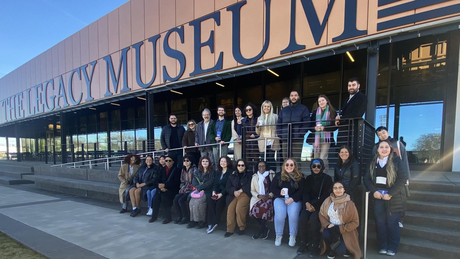 Pace students and faculty posing for the camera outside of the Legacy Museum. 