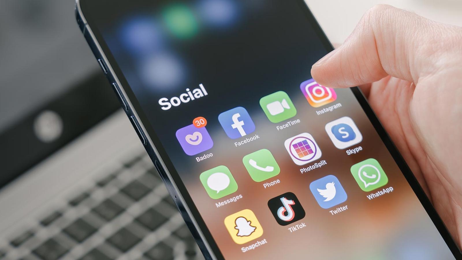 photo of phone with social media icons