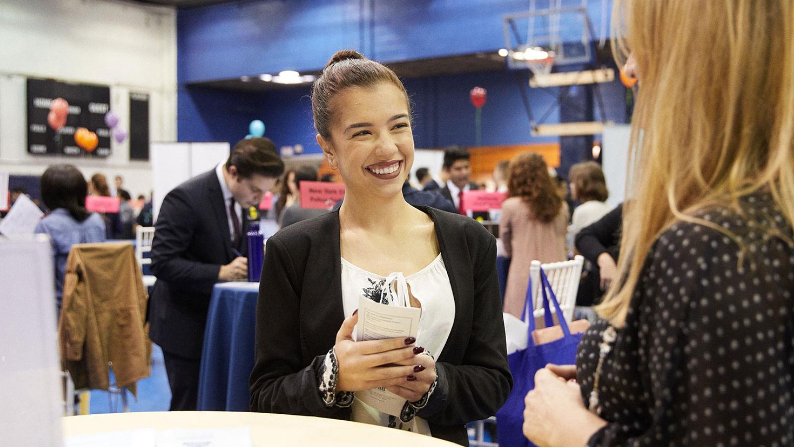 Student meeting with a prospective employer at a Career Fair held at Pace University.