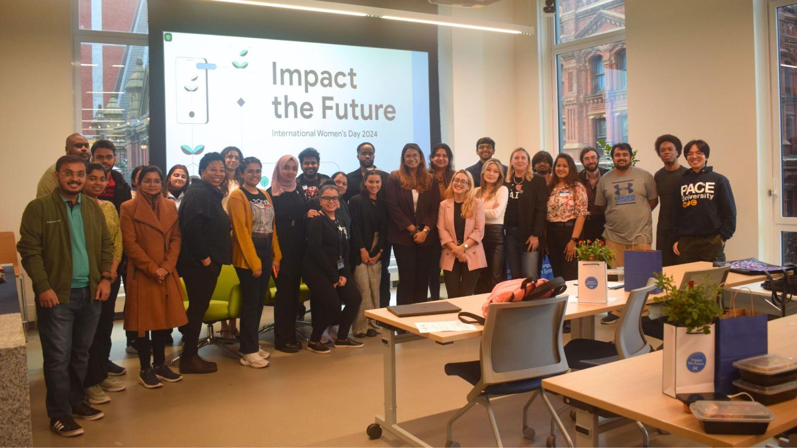 The speakers and audience members at Pace Seidenberg's Google Women TechMakers International Women's Day event, smiling and posing for a group photo in the Design Factory space.