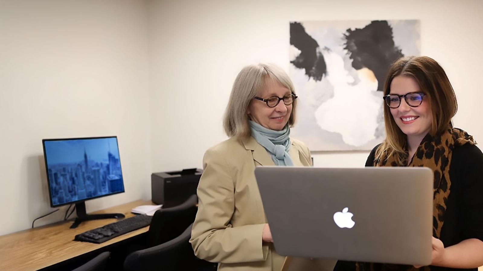 Pace University Psychology NYC department faculty member looking at a laptop with a student