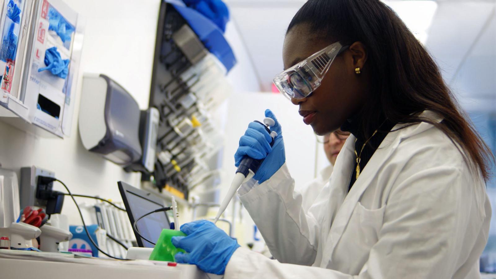 Pace University's Chemistry and Physical Sciences student Immala Rousier with Associate Professor Eric Chang, PhD, working in the lab with equipment on the New York City Campus