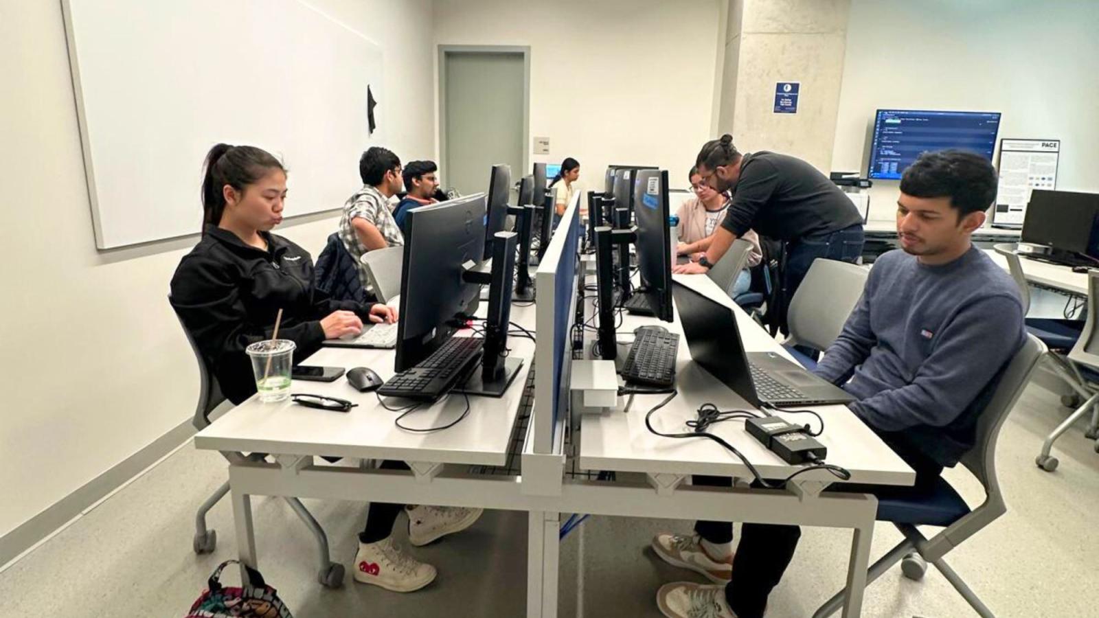 Pace Seidenberg students sitting in front of their computers in the Computational Intelligence Lab during a workshop.