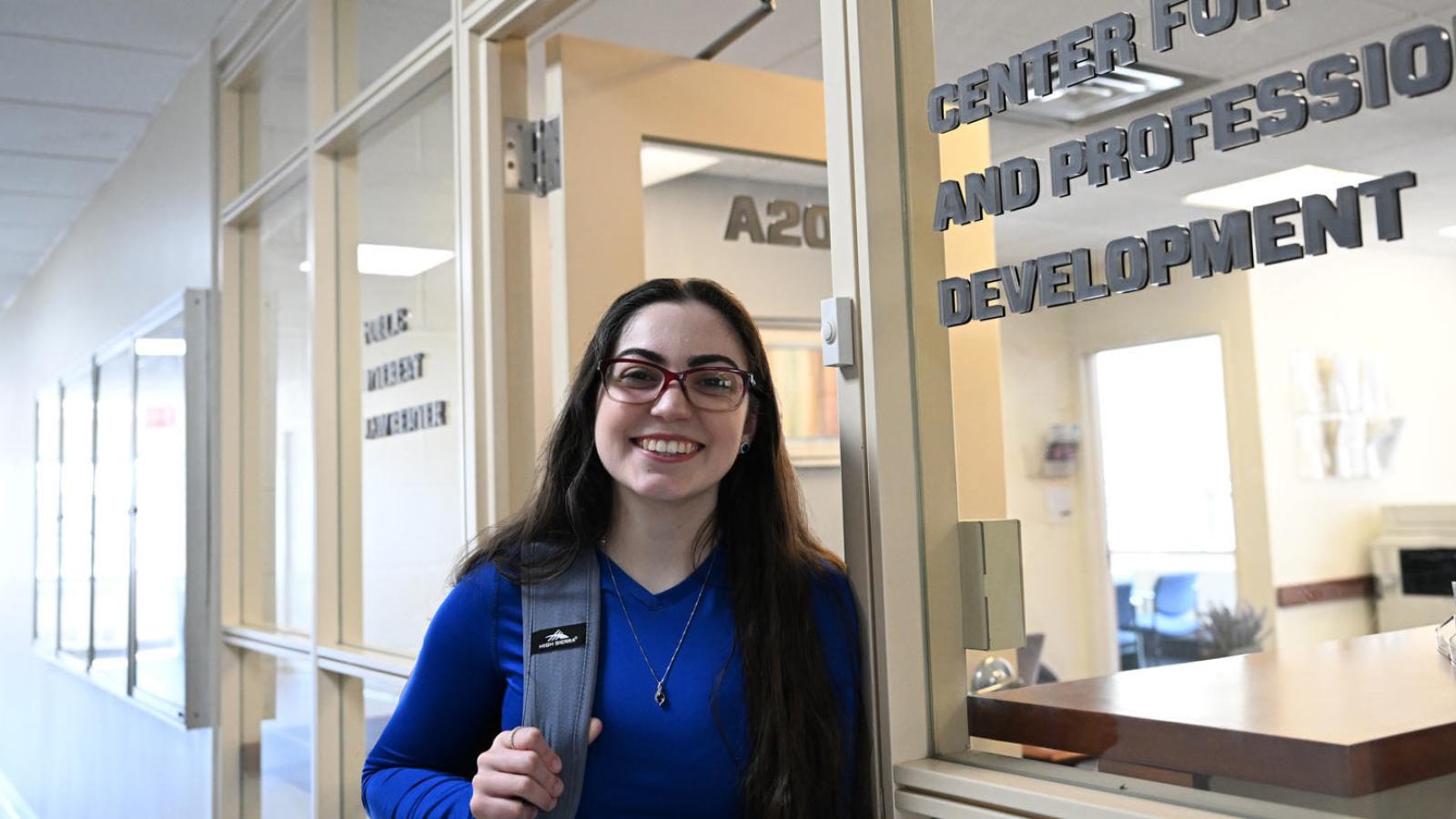 Student standing outside of the entrance of the Elisabeth Haub School of Law’s Center for Career and Professional Development.