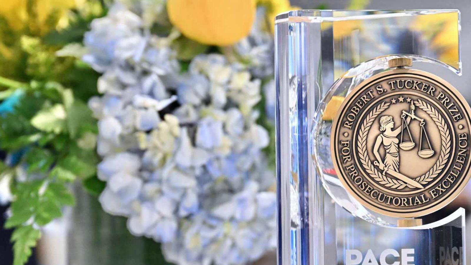Tucker Prize award with flowers in background