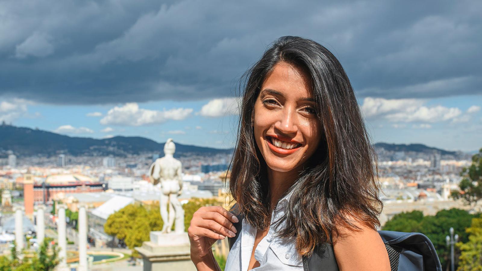 Student posing with view of Spain in background