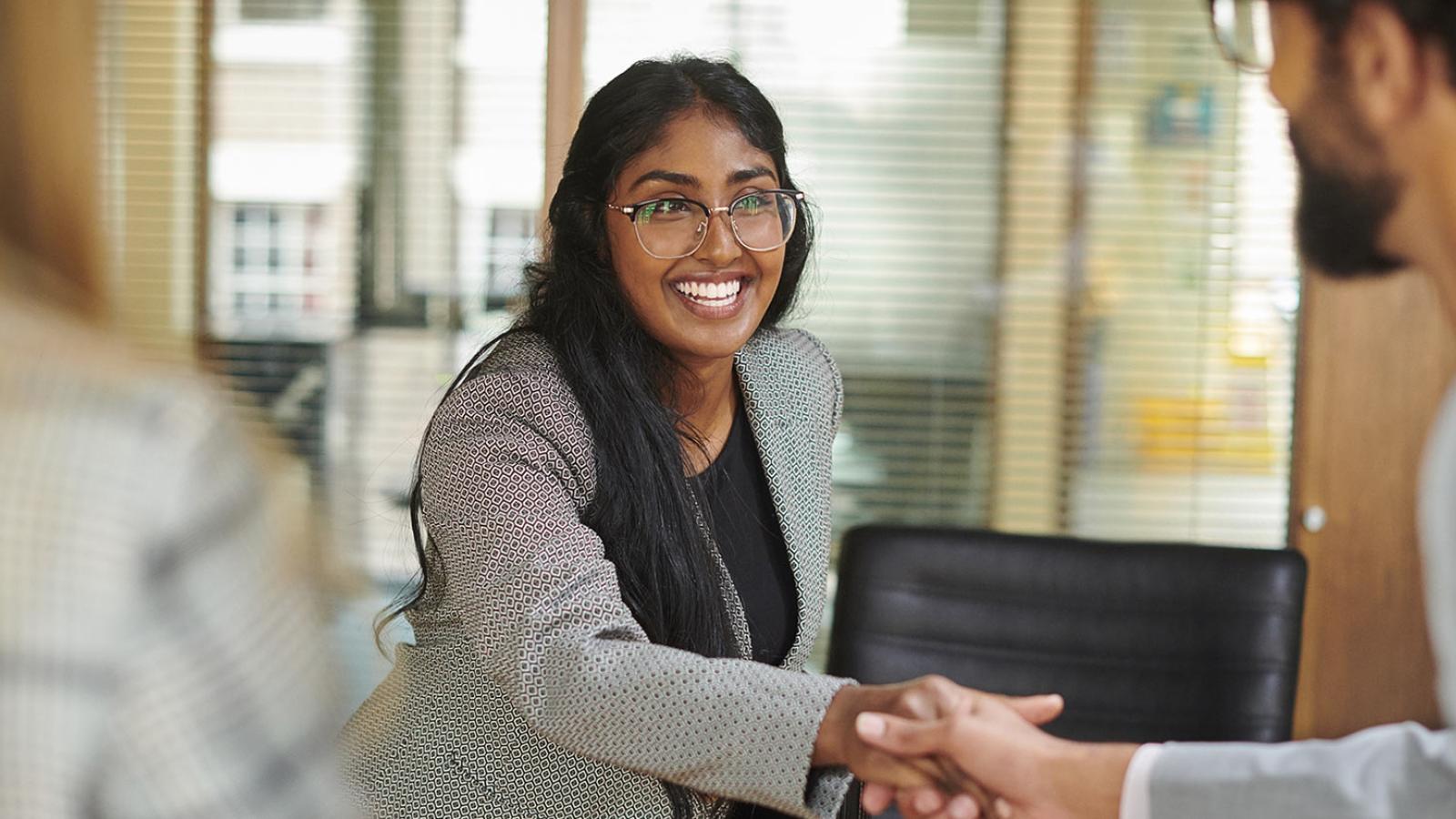 Elisabeth Haub School of Law student shaking hands with another person