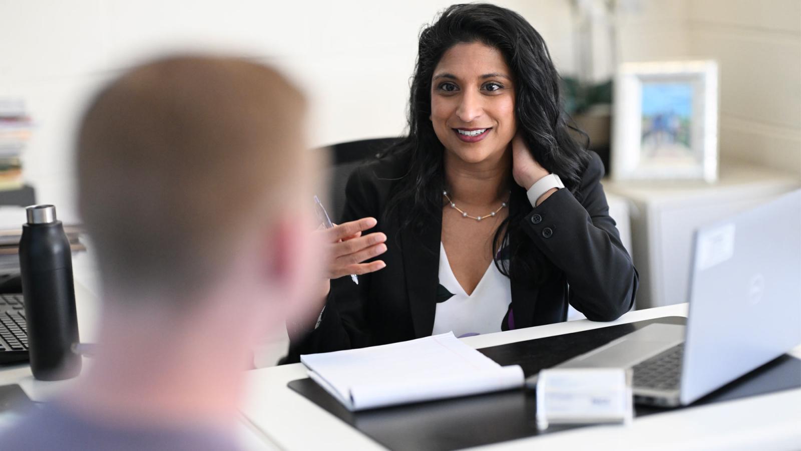 people talking in an office at the Elisabeth Haub School of Law