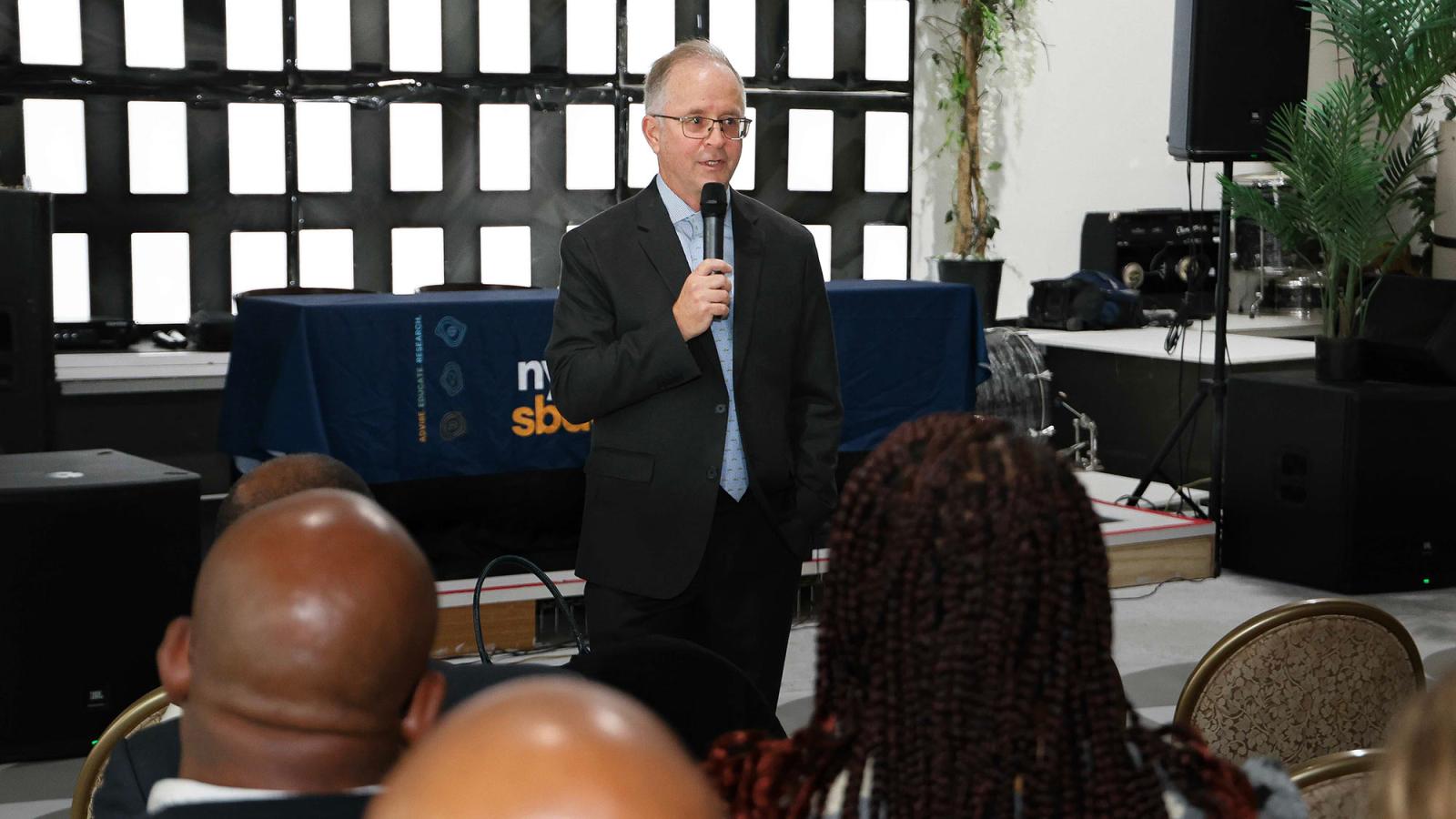 Regional Director of Pace’s SBDC Andrew Flamm addresses local Flatbush small business owners and operators.