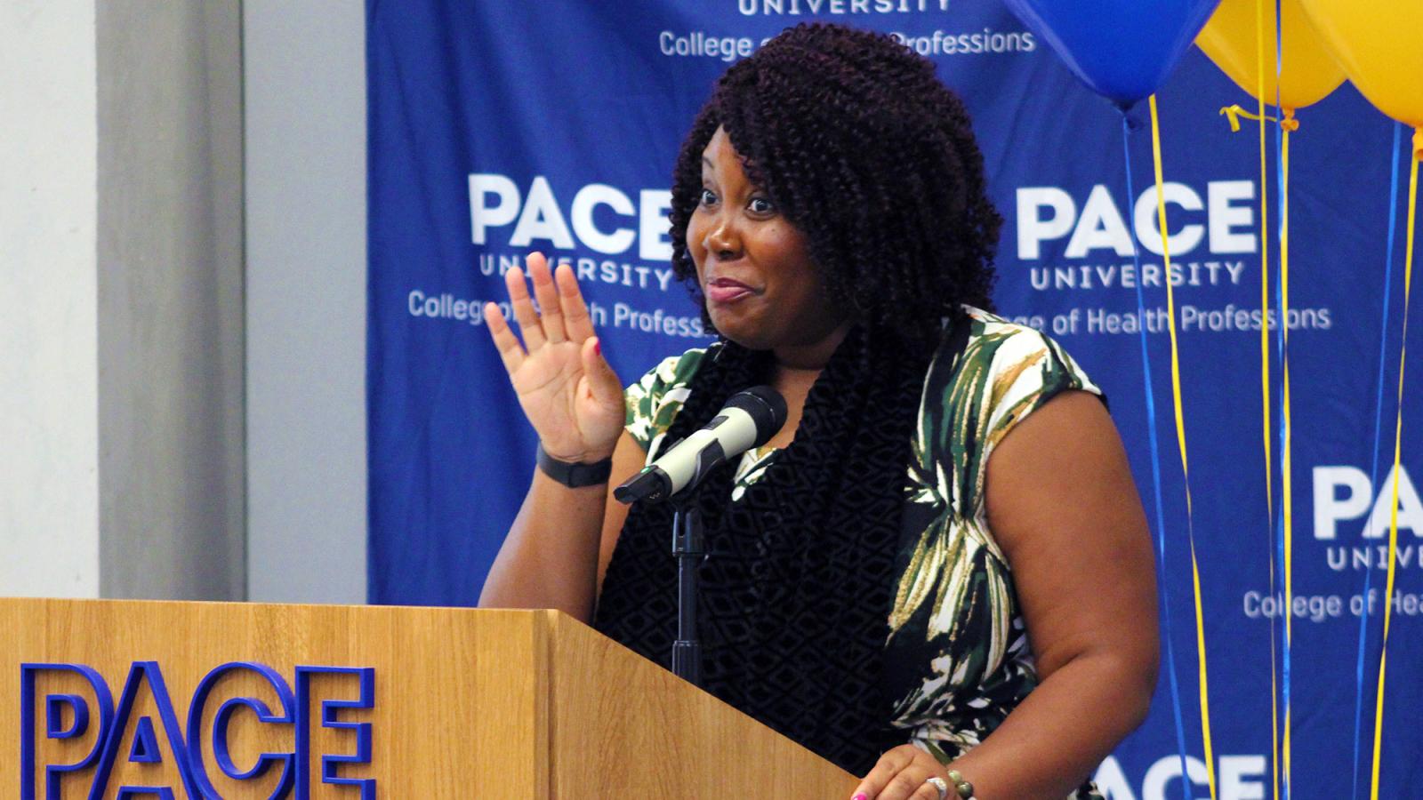 College of Health Professions Professor Kyomi Gregory-Martin at a podium.