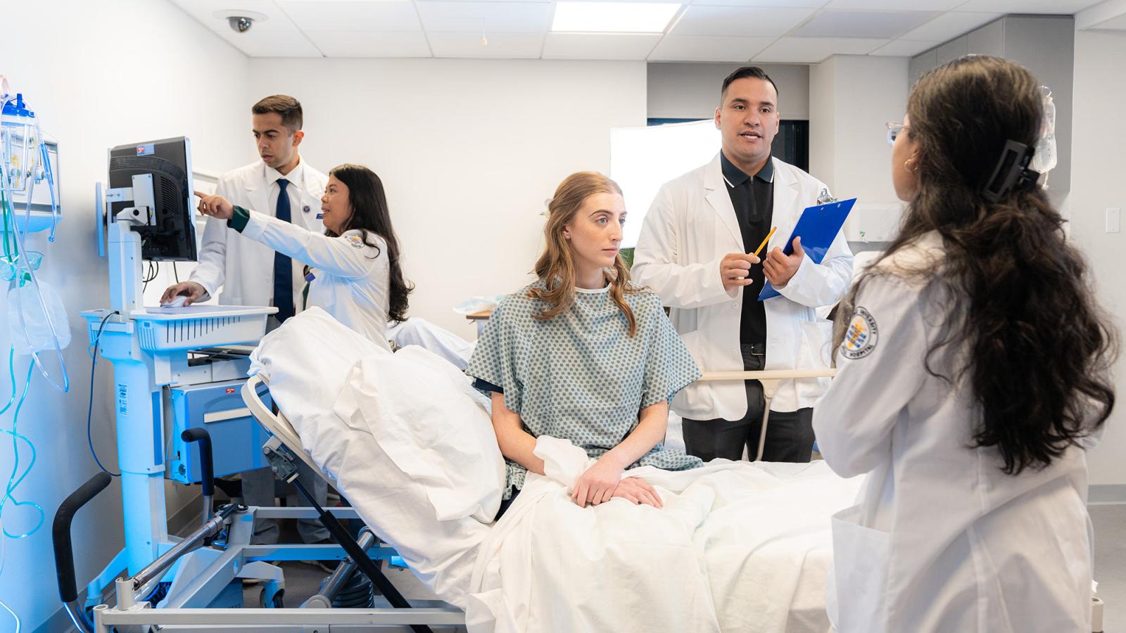 Pace University College of Health Professions Lenox Hill Hospital Physician Assistant students mock examination of patient.