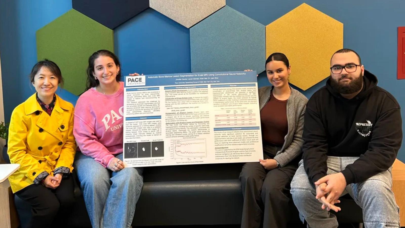Pace University Professor Juan Shan with students and their research poster.