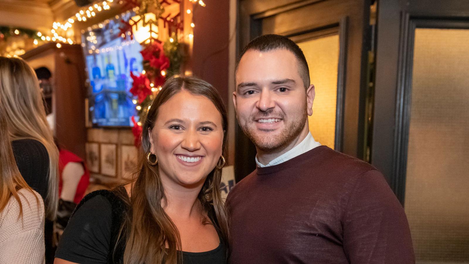 Two Pace University alums smiling at the camera.