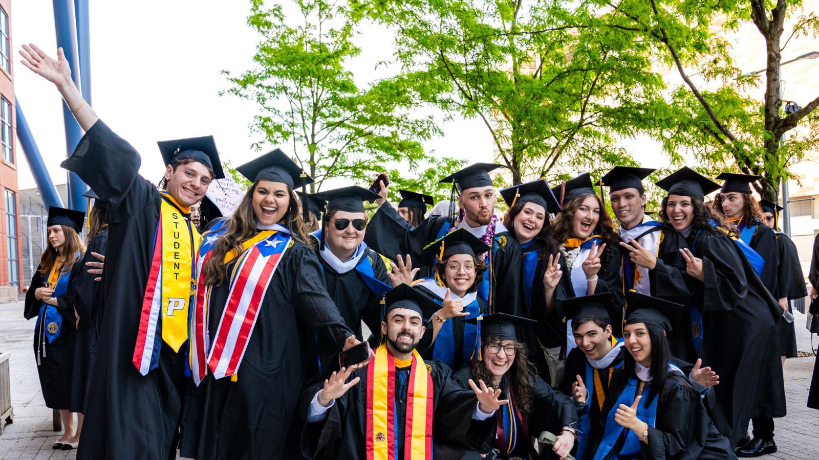 Group of Pace University graduates posing for the camera.