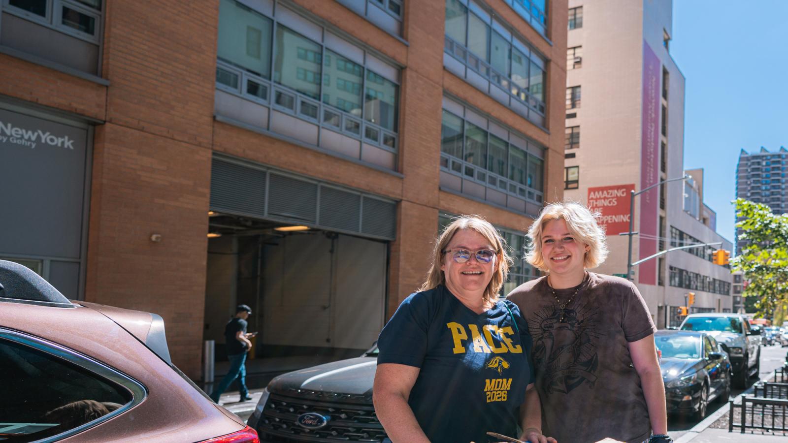 A Pace parent and her student posing outside of 33 Beekman.
