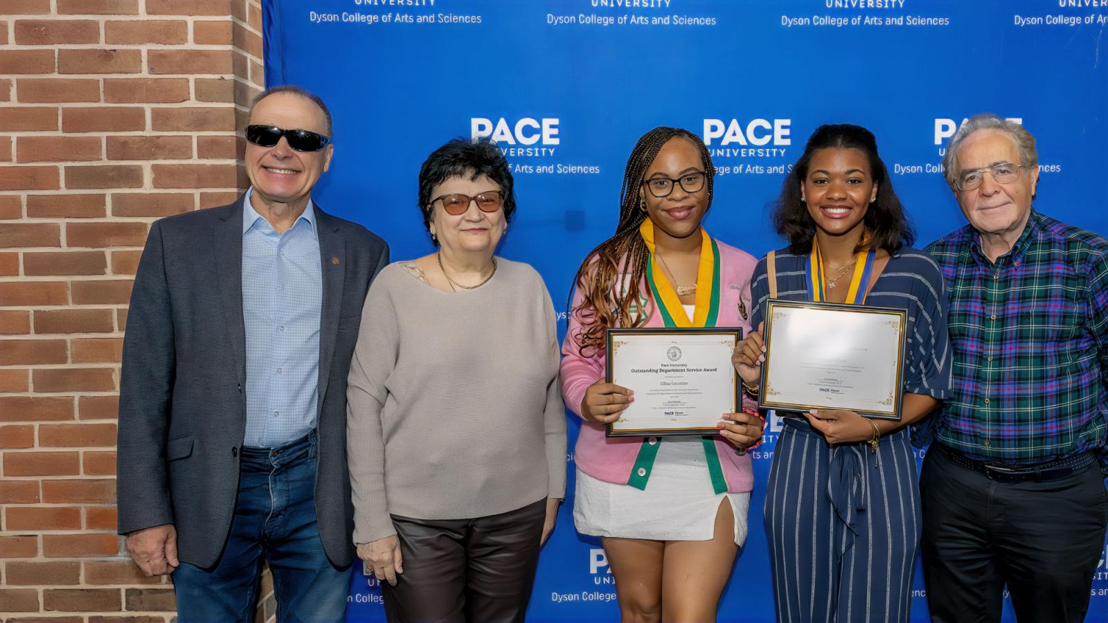 Pace University Chemistry and Physical Sciences department faculty and student award winners posing in front of a blue backdrop